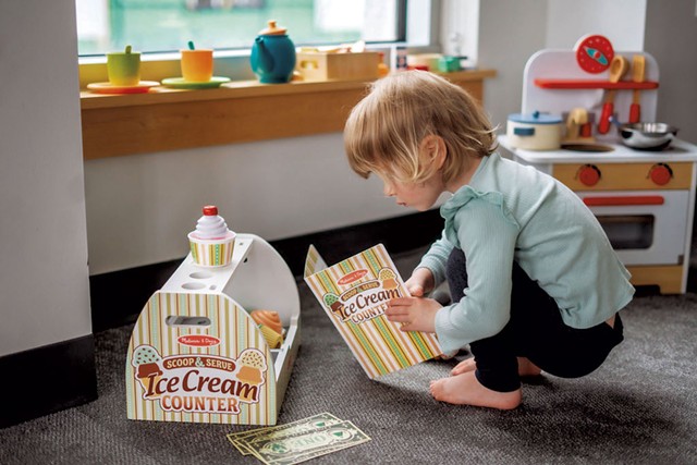 A child with toys from Playscape Vermont - COURTESY OF M. FITZGIBBONS PHOTOGRAPHY