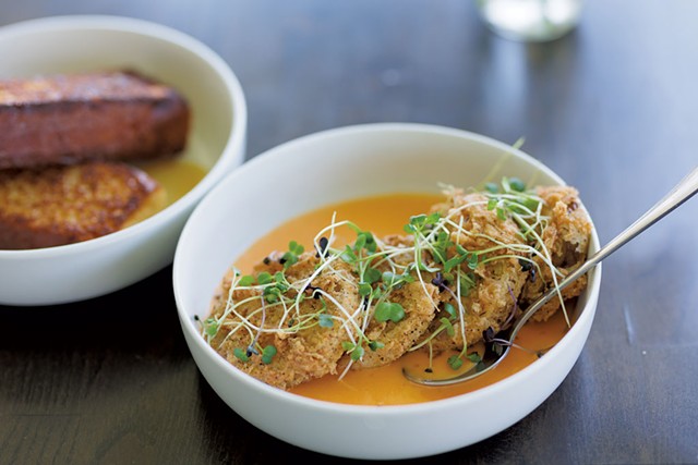 Fried green tomatoes served in a sweet and spicy cream sauce and topped with microgreens at Maple Soul - BEN DEFLORIO