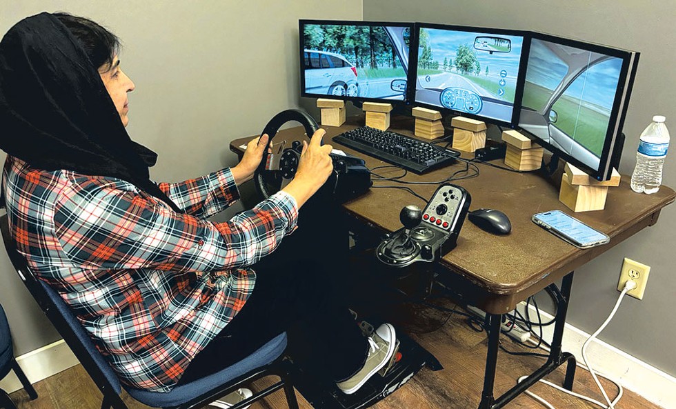 Zarghoona Jalalzoy driving via a simulator - KEN PICARD ©️ SEVEN DAYS