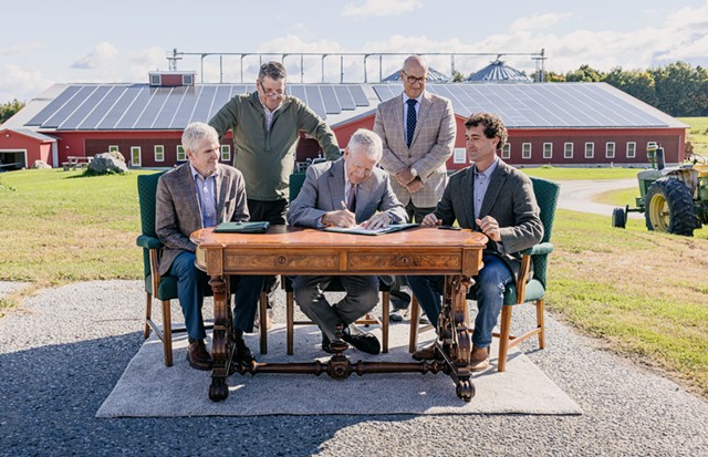 UVM's Richard Cate (center) signs the Nordic Farm lease - COURTESY OF JOSHUA DEFIBAUGH/UVM