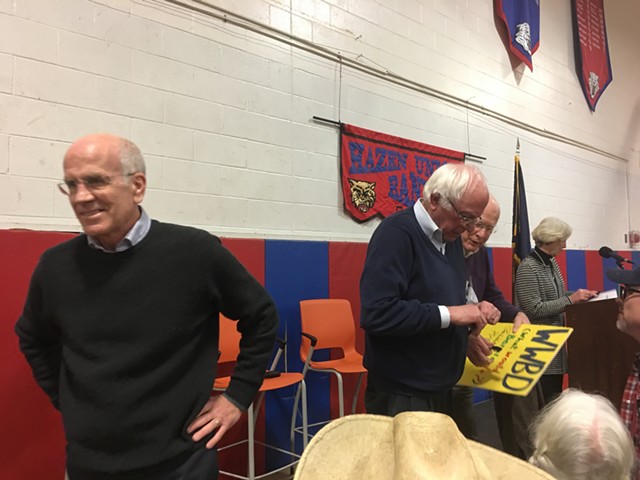 Welch, Sanders and Leahy autograph a “What Would Bernie Do?” sign. - JOHN WALTERS