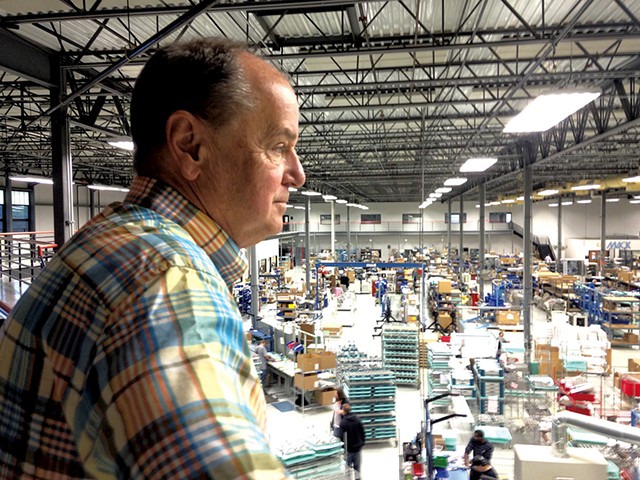 Jeff Somple, president of Mack Molding, looking out over the plant floor - MOLLY WALSH