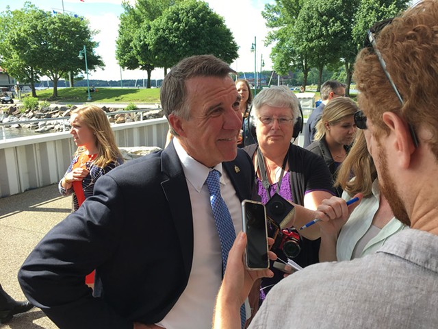 Gov. Phil Scott speaks with reporters after the announcement of the Vermont Climate Pledge Coalition - JOHN WALTERS