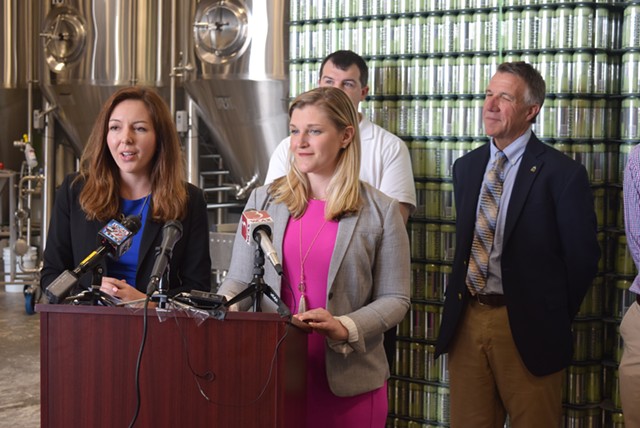 Amanda O'Brien (left) and Laura Pierce talk Monday at Fiddlehead Brewing about helping young adults find work in Vermont as Gov. Phil Scott (right) and Paul Dame  look on. - TERRI HALLENBECK