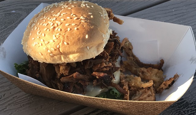 Burger topped with BBQ pork - SUZANNE PODHAIZER