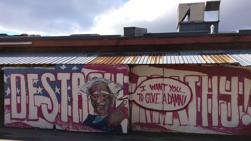 Anthill Collective's Bernie Sanders mural behind ArtsRiot