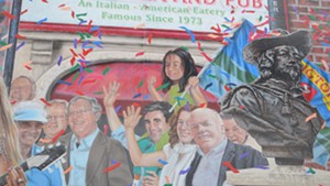 Miro Weinberger, with his daughter Li Lin sitting astride his shoulders, in the "Everyone Loves a Parade" mural