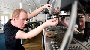 Ben Colley working on an Italian espresso machine at Down Home Kitchen in Montpelier