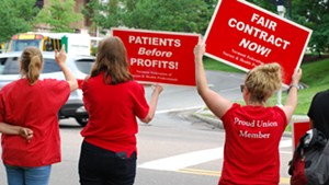 Nurses at a honk-and-wave rally outside the hospital