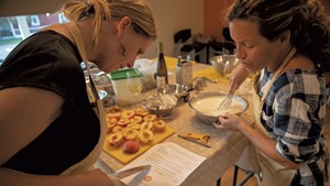 Students preparing peaches for dessert at a Richmond Community Kitchen class