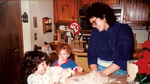 Evan Ross (center) making cookies as a child