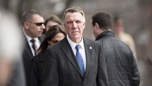 Gov. Phil Scott arrives at the statehouse for the bill-signing ceremony.