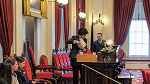 House Speaker Mitzi Johnson (D-South Hero) cleaned off her podium after accidentally smashing a glass lampshade with a gavel.