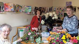 Residents arranging flowers from their garden