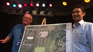 Pat Burns, left, and John Tashiro show plans for City Market's South End store.