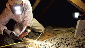 Brian Hyde of Energy Co-op of Vermont, sealing gaps in a Colchester attic