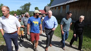 Stony Pond Farm owner Tyler Webb leads Vermont Sen. Patrick Leahy on a tour of the 300-acre dairy farm in Fairfield.