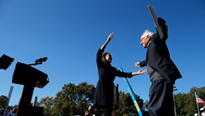U.S. Rep. Alexandria Ocasio-Cortez and Sen. Bernie Sanders prepare to embrace at the rally.