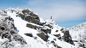 A snowboarder on the ridgeline of Mount Mansfield