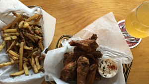 Dry-rubbed chicken wings and fries at St. Paul Street Gastrogrub