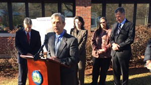 Robert Sand, Gov. Peter Shumlin's liaison to Criminal Justice Programs, speaks at a press conference outside the Chittenden Regional Correctional Facility in South Burlington, with Shumlin in the background.
