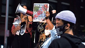 Protesters with copies of Seven Days at last Thursday's demonstration in Burlington