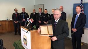 Vermont State Police Captain J.P. Sinclair displaying evidence at a press conference