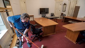 Custodian Mike Metcalf readying the coatroom at the Statehouse