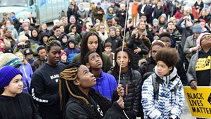 Joelyn Mensah raising the Black Lives Matter flag at Montpelier High School