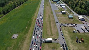 Cars line up to get food during a Farmers to Families Food Box drop last year