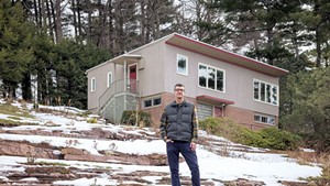 Devin Colman in front of his favorite midcentury house in Burlington