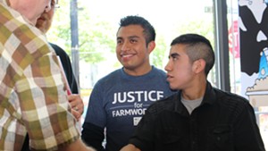 Victor Diaz, center, after discussing the “Milk with Dignity” campaign with a Ben & Jerry’s representative.