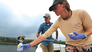 Rick Levey and Kelsey Colbert gathering water samples in Lake Memphremagog