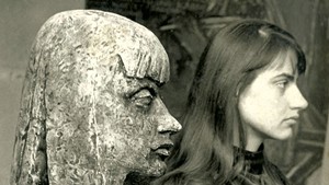 Elka Schumann standing beside a sculpture of her made by her future husband, Peter Schumann, in Hanover, Germany, in 1958