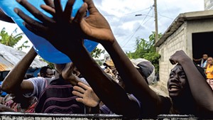 People waiting at the water distribution  in southwest Haiti