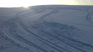 Making ski turns in the afternoon sunlight