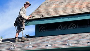 Robert Volk Jr. working on a slate roof