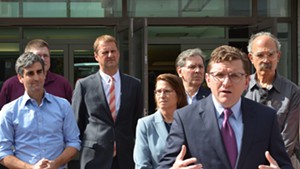 From left: Burlington Mayor Weinberger, John St.Hilaire of Vermont Gas, Corix chief operating officer and vice president Eric van Roon, Dawn LeBaron of UVM Medical Center, Don Sinex, BED director Neale Lunderville and Jan Schultz announce plans to pursue district heating on Wednesday.