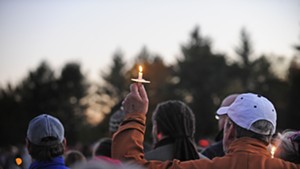 Holding a candle aloft at the vigil