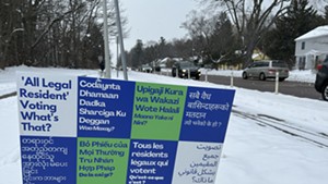 A sign in Burlington promoting non-citizen voting in several languages