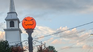 A pumpkin-headed lampost