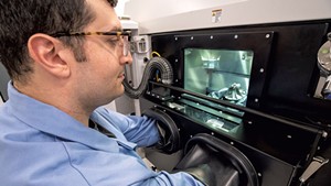 Engineer Nikolas Eliopoulos working with metal additive technology at the Advanced Manufacturing Center