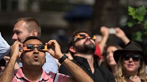 Spectators looking up at the partial solar eclipse in New York in 2017