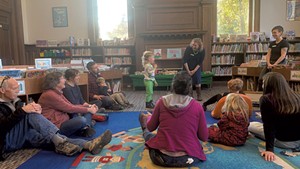 A graduate of the 1000 Books Before Kindergarten program is recognized at  Fletcher Free Library for his accomplishment.