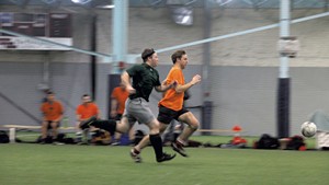 Tim Ashe (in orange) playing soccer in 2017