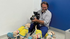 Directer Andy Mitchell getting footage of soon-to-be service dogs.