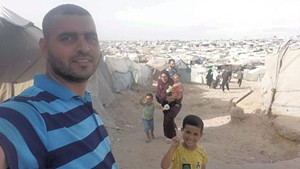 Yasser with his wife and children in Gaza