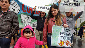 Cesar Alex Carrillo, left, with his young daughter and wife, leading a 2016 march to urge the release of a migrant worker.