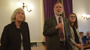 Rep. Dave Sharpe addresses the Democratic caucus Thursday as Rep. Janet Ancel, left, and Rep. Jill Krowinski look on.