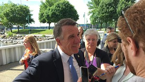 Gov. Phil Scott speaks with reporters after the announcement of the Vermont Climate Pledge Coalition
